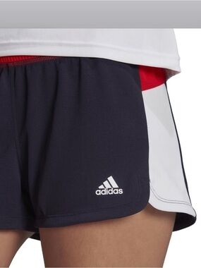 ADIDAS WOMEN'S COLOR-BLOCK
PACER WOVEN SHORTS, LEGEND INK/VIVID RED. Size: med